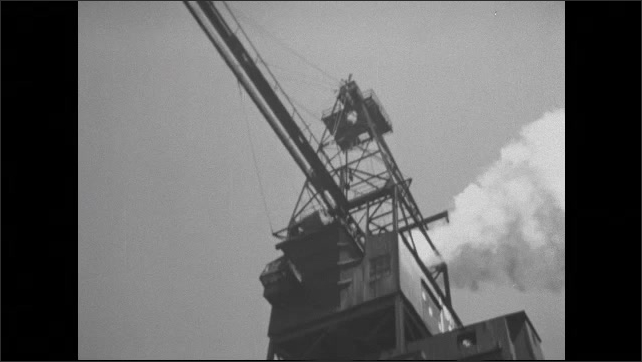 1930s: Low angle shots, crane lifting cargo. 