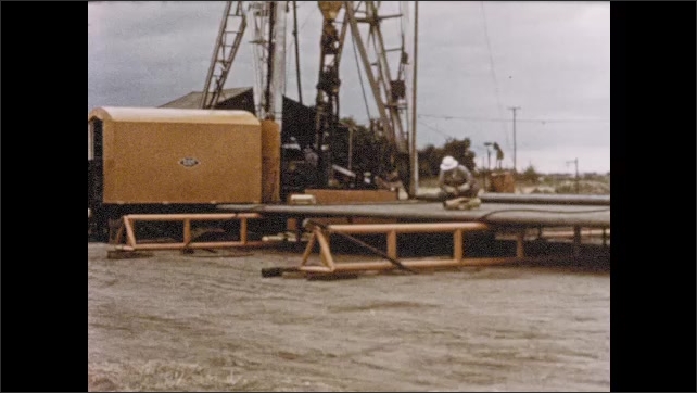 1950s: Car approach oil field and rig as narrator celebrates church expansion in Salina Kansas.
