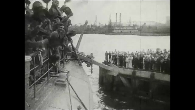 1910s Men wave to ship from docks. Soldiers lean from ship and wave hats. Steam whistle blows on ship. Sailors use binoculars on deck. Ships sail across the horizon.