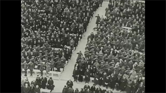 1910s Men wrap body and place it in wooden casket. Soldiers salute in audience of burial ceremony. Woodrow Wilson speaks near flowers and casket at funeral. Woman measure soldier for prosthetics.