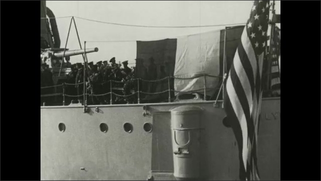 1910s Soldiers carry flag-draped coffin through crowd. Soldiers stand on deck of ship. Man pins medals on corpse during funeral ceremony.