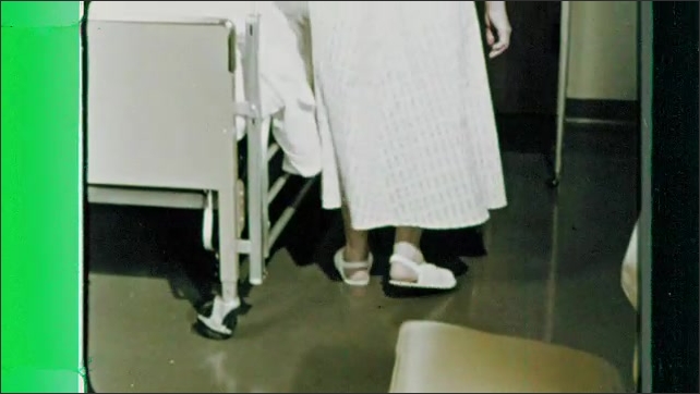 1960s: Animation.  Mop makes yellow line on floor.  Woman disappears.  Nurse.  Man washes hands in hospital hallway.  Patient gets into bed.  Green fog appears around hospital beds.
