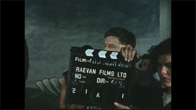 1600s: Man in costume talking into camera, laughing. Woman with clapboard, close up of man in costume talking, woman enters. 