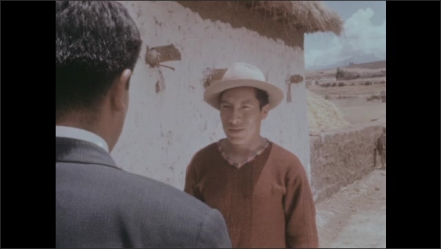 1950s: Girl wraps thread around her hand and fingers. Woman weaves. Man in hat talks to man in suit. Boy walks into llama pen, boy herds llama across desert. 