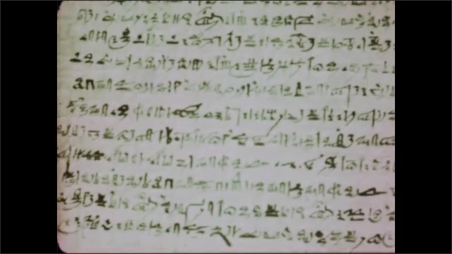 1950s: Hieroglyphics on stone. Ancient texts on papyrus. Boy inscribes Greek alphabet on tablet.