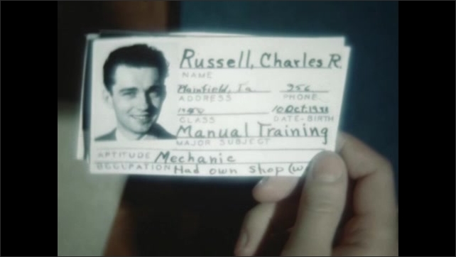 1940s: Hand holds identification card of teen boy named Charles Russell.