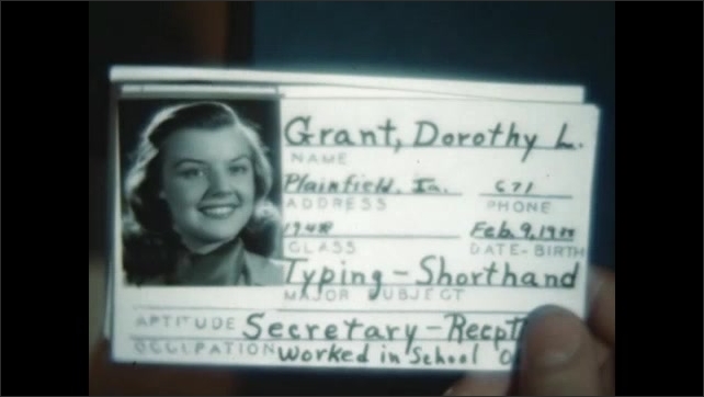 1940s: Hand holds identification card of teen girl named Dorothy Grant with her smiling photo and statistics.