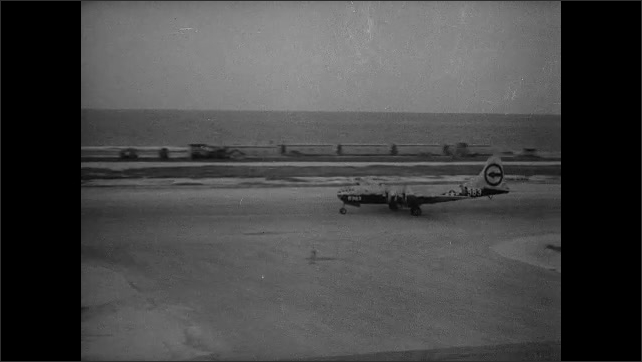 1940s Bikini Atoll: Bomber planes rolls down runway.