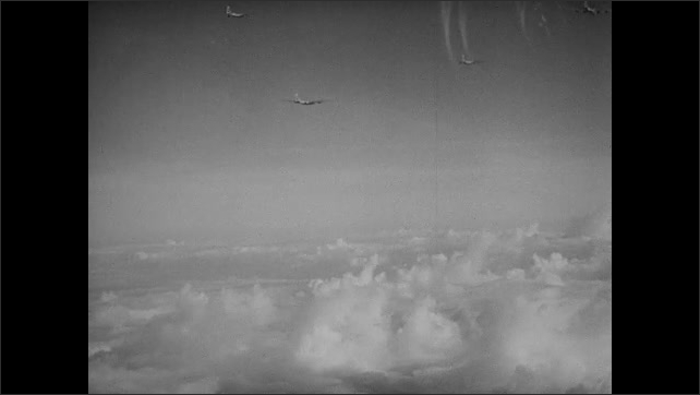 1940s Bikini Atoll: Soldiers talk in cockpit of B-29 bomber plane. Bomber planes fly in formation. Military planes fly in formation above clouds and ocean.