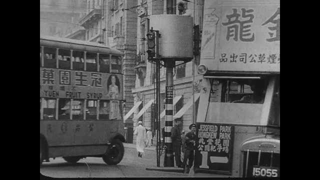 1940s China: Activity in streets of Shanghai. Map of Shanghai. Soldiers march in streets.