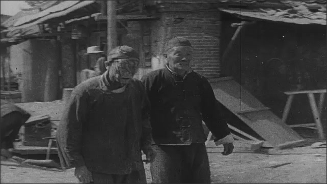 1940s China: Woman hugs injured man. Japanese soldier smiles. Man kneels in front of bodies. Injured people in the street. Injured civilians traverse village. Chinese politicians give speeches.