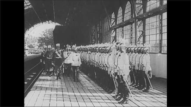 1910s Russia: Russian leaders escorted into a car. Russian soldiers lined up on train station platform as Russian leaders parade in front. Hundreds of people moving through a St. Petersburgh square.