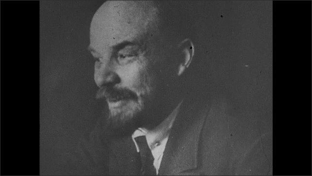 1910s Russia: Lenin is interviewed and speaks animatedly. Lenin in cap and coat speaks to people outside. 
