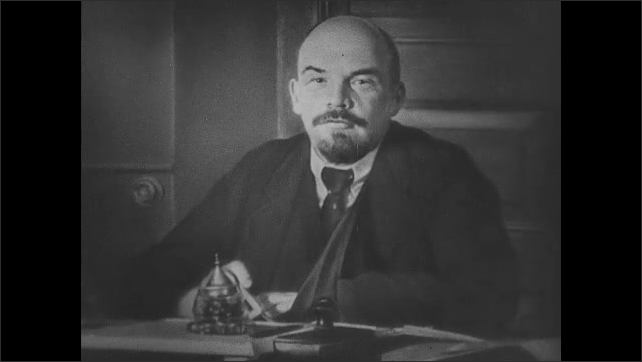 1910s Russia: Lenin speaks outdoors. Buildings of Moscow with onion domes. Portrait of Lenin at desk. Lenin smiles, talks and waves to people. 