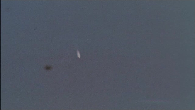 1960s: Missile begins descending in the sky, a bright blaze in the sky. 