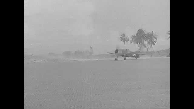 1940s Pacific Islands: Propellor planes lands on patterned sand. Drum roller construction truck on sand. Dump trucks unload dirt by palm trees.