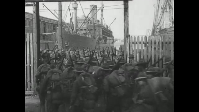 1910s Virginia: Soldiers gather on pier, board ship. Intertitle card. Soldiers march onto pier. Soldiers board ship. 