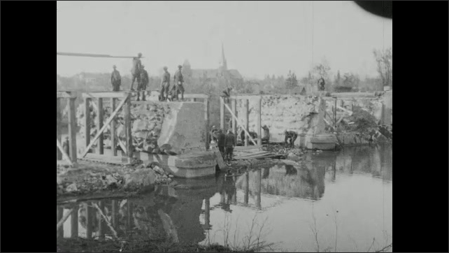 1910s: Men construct building. Men build bridge over river.