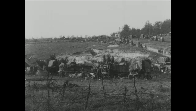 1910s: Soldier fills trough with water. Soldiers movie about military camp.