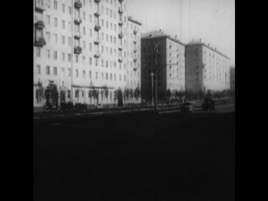 Russia: 1950s: view along street and road. Buildings by road. View ...