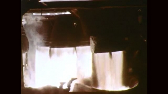 1960s: Rocket engines fire. Rocket booster engine fires from launch pad ...