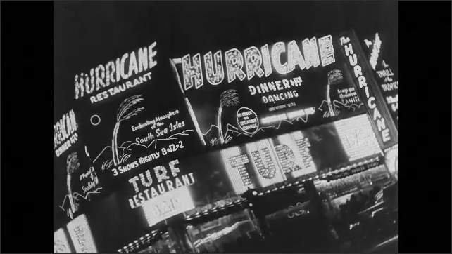 1940s:  Neon sign Jack Dempsey Broadway Bar. View of neon signs and theatres on Broadway in New York. Hurricane Dinner and Dancing. Roseland neon sign. 