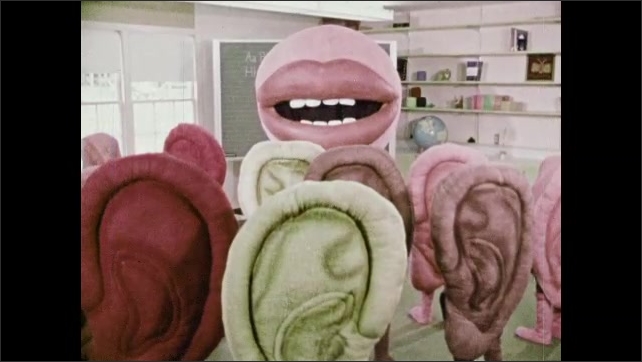 1970s: Person in giant mouth costume is talking. Mouth stands talking ...