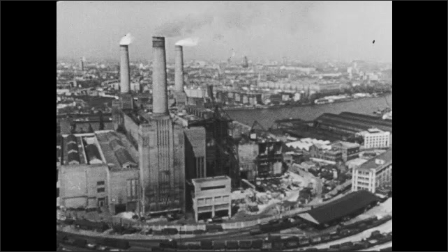 1940s Britain: Skyline of London with water reservoirs on roof. Woman turns on tap in flat. Child touches radiator. Factory and smokestack in city.  Boat on ocean. Cars leaving factory.