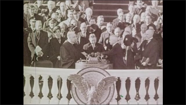 1940s: President Truman waves hat and speaks from motorcade. Signatures on bible in display case. President Truman shakes hands at swearing in ceremony.