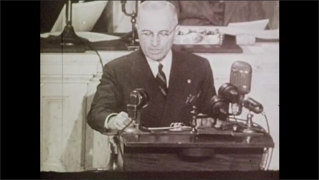 1940s: President Truman delivers speech at podium. Fountains spray water in front of the White House. President Truman and George Marshall look at globe in office.