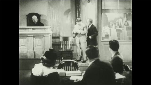 1930s: Fire hose sprays bird off light in courtroom. Bailiff and Curly tie a knot in the fire hose. Larry reads note out in court and all celebrate.