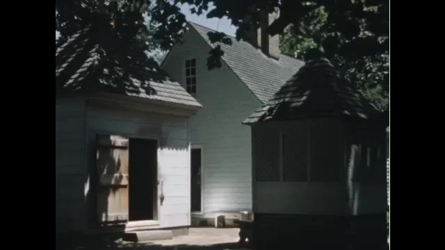 1760s: View of house, woman carrying pot walks past camera. Woman with clapboard.  