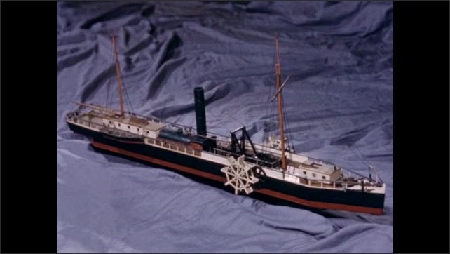 1800s: Film slate. Model paddle boat. Engine and wheels of model boat.