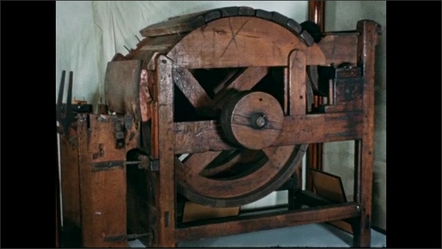 1800s: Film slate. Large round wooden machine.