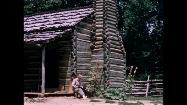 1800s: Cloud of steam. Man sitting outside log cabin, boy runs up to him.