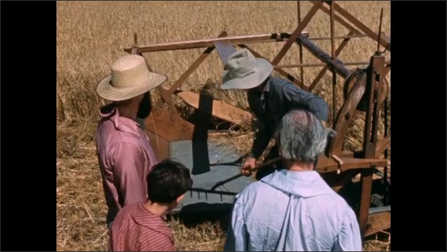 1800s: Film slate. Man showing farmer how harvester works. Two men having a discussion.