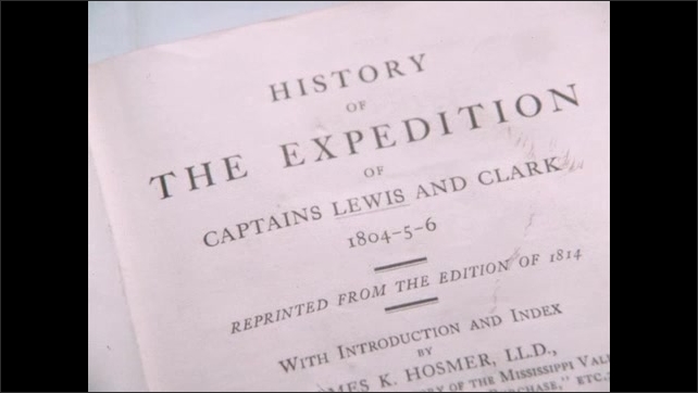 1800s: Person holds film slate. Person points to Snake River on map. Painting of man. Title pages of books about Lewis and Clark's expedition. Drawings of Lewis and Clark in book.