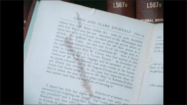 1800s: Drawings of Lewis and Clark on pages in books. Pages in book. Book is closed on placed on shelf with other books.