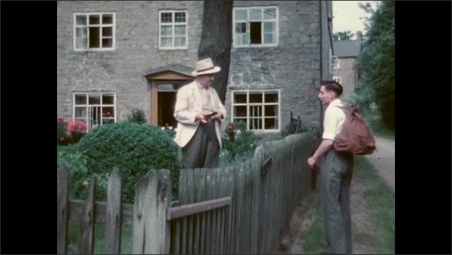 1950s: Clapboard, shots of man walking, stopping at fence, talking to man in yard. 