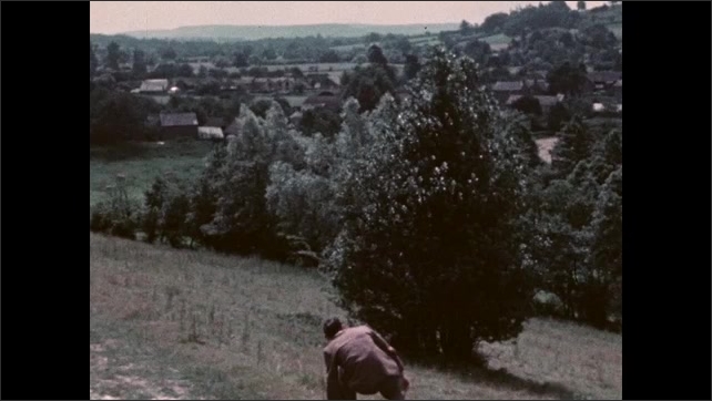 1950s: Clapboard, shots of man standing from ground, walking down path. 