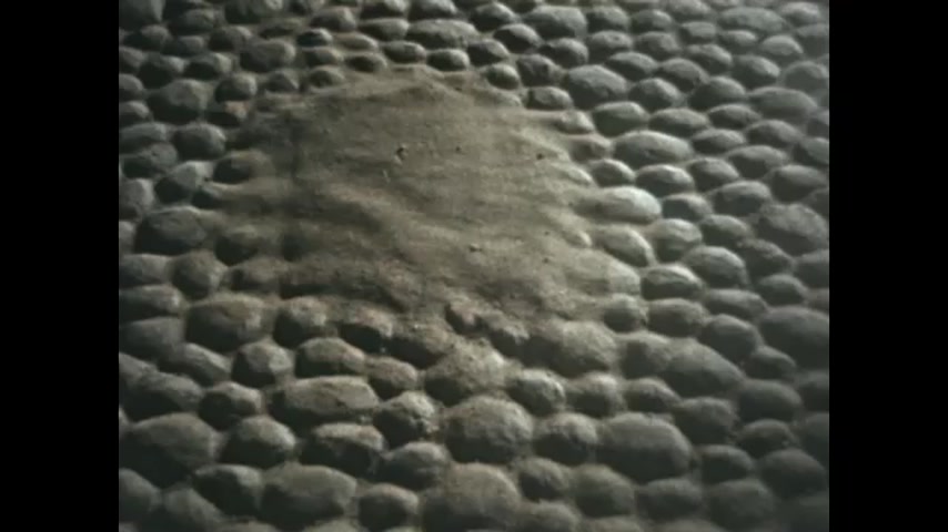 1770s: Pile of dirt on cobblestone street. Person sweeps sand across cobblestone street.