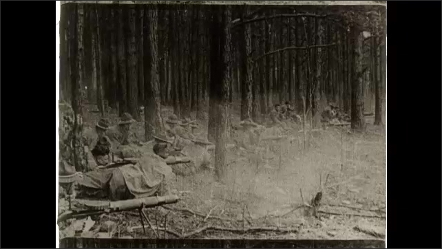 1910s: Man stand at attention in rows holding wooden replicas of rifles. Man lay on ground in forest firing rifles. Soldiers train on obstacle course. People on navy ship.