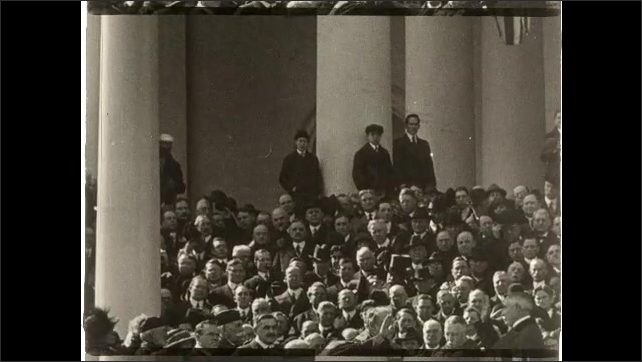 1910s: Dignitaries signing peace treaty in Palace of Versailles. Intertitle card. Card of people, people clap hands. Intertitle card.