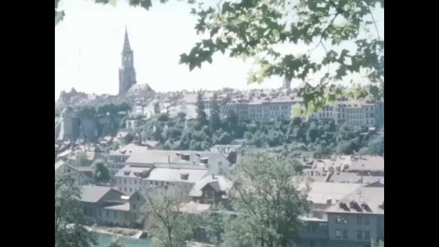 1950s: Swiss city and church. Brown bear in bear pit in Bern.