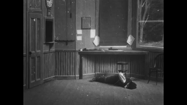 1900s: Train station.  Child enters office to find man laying on floor.  Child shakes man and throws water in his face.  Child prays.  Man wakes.