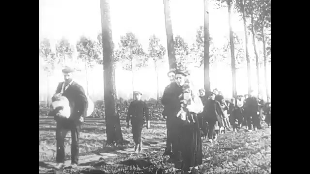 1910s: Families walk through forest.  Livestock pull carts.  Headline reads "WAR DECLARED ON GERMANY."  Soldiers march.  Officer salutes.  Castle.  Street.  Men on horseback.