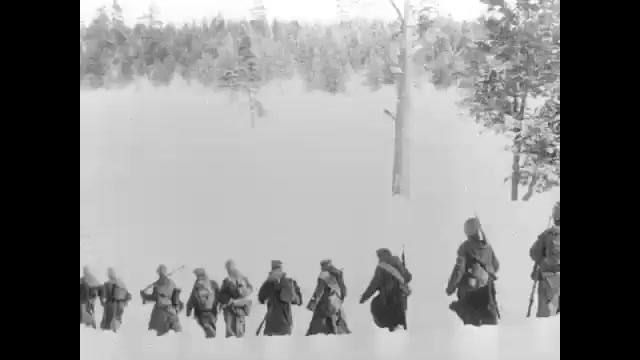 1910s: Soldiers march through snowy mountains.  People celebrate in street.  Men pass out papers.  Men carry flags.  Man gives speech.