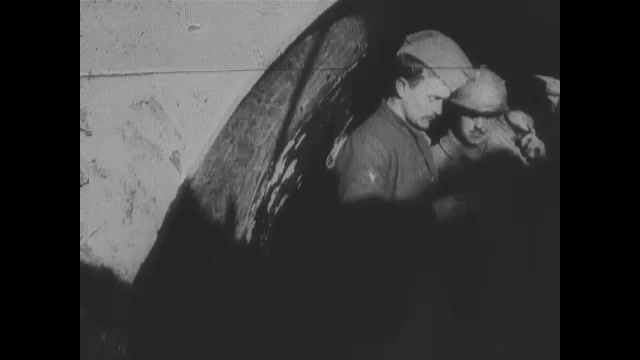 1910s: Soldiers in bunker in ground. Soldier on bridge in trench.