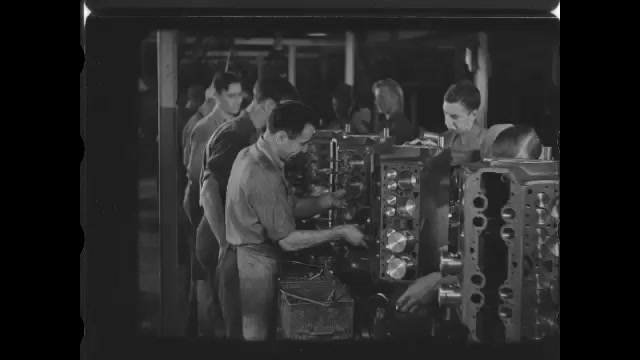 1920s: Men on assembly line in factory, build car engines. Person turns rotary part in machine. Part in saw. Foundry, hot liquid metal in furnace.