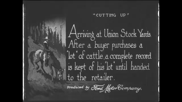 1910s: Intertitle. Cattle in pens. Men walk along the fences of the pens. Herd of cattle move through a chute.